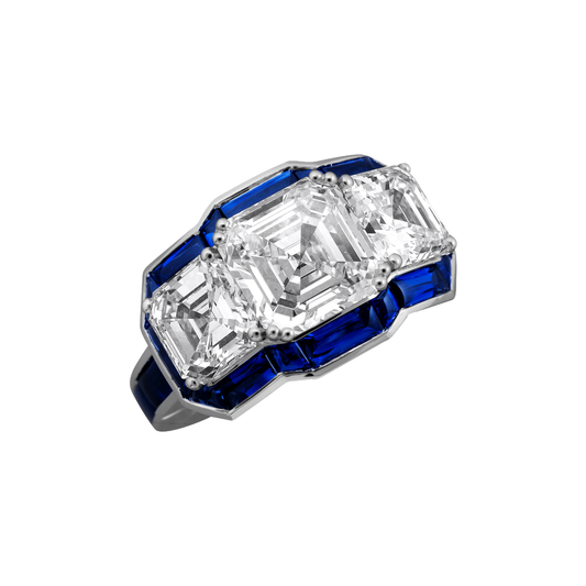 Three Emerald Cut Diamonds Surrounded by Buff-Top Sapphires